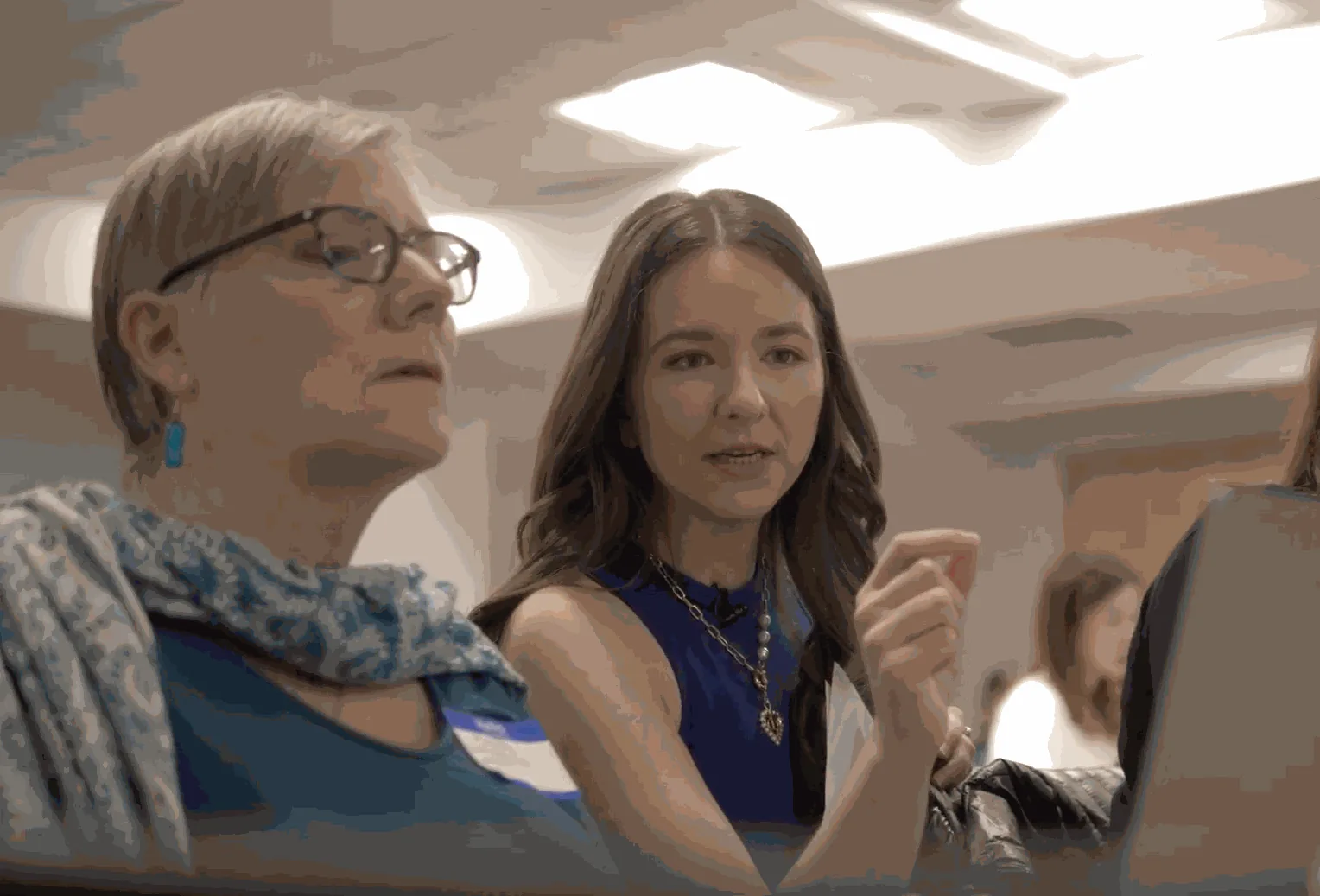 Joan helping a workshop participant at a laptop
