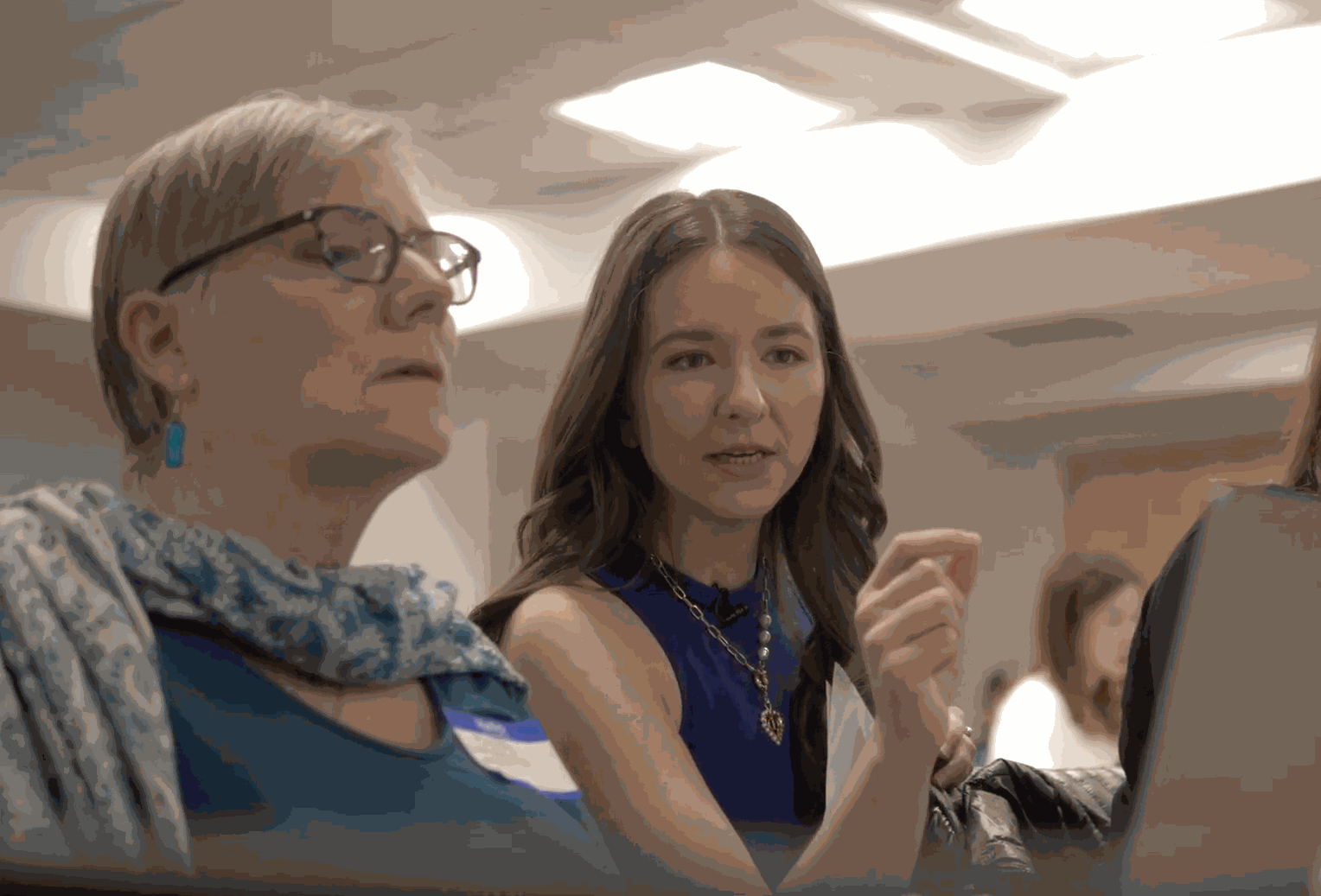 Joan helping a workshop participant at a laptop